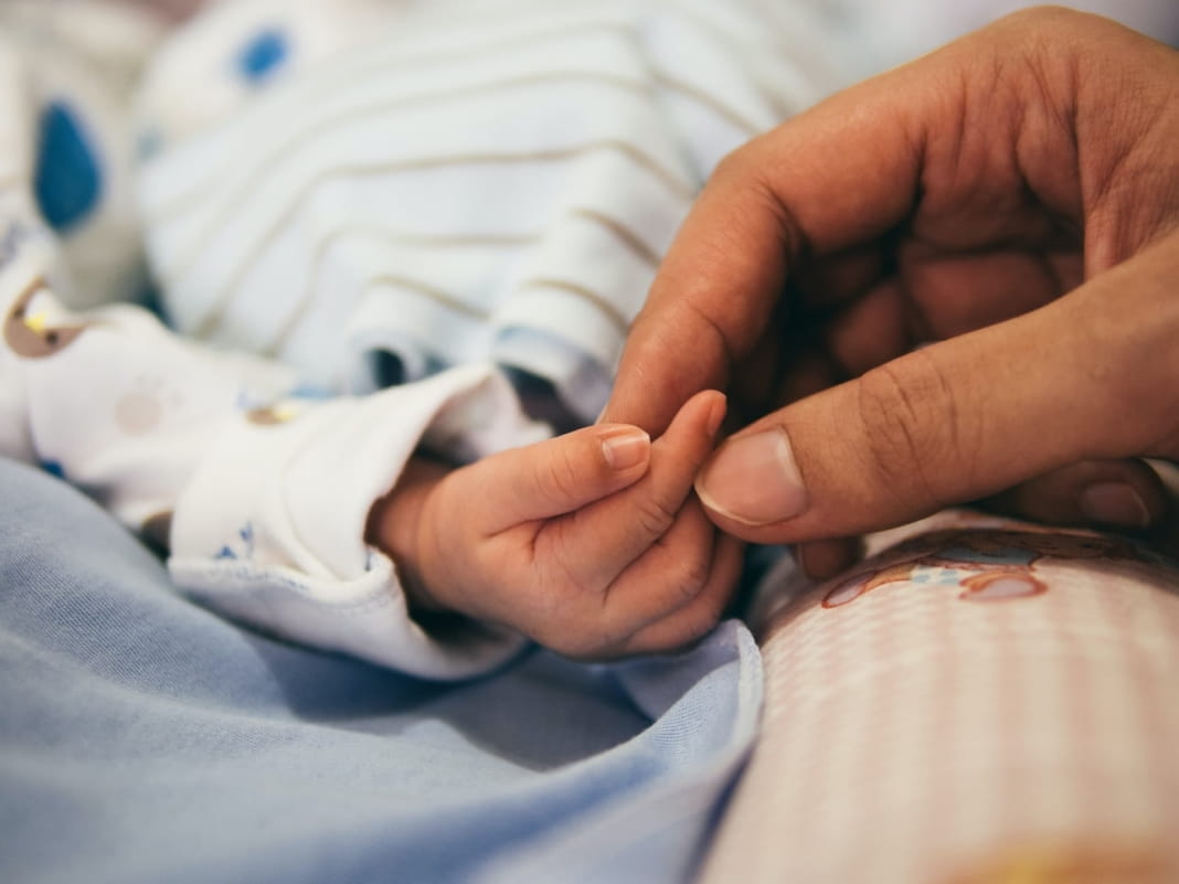 Holding a baby's hand by Aditya Romansa